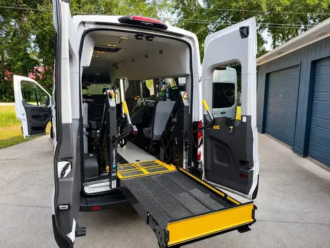 Angled view of a deployed BraunAbility wheelchair lift platform at the rear of the van