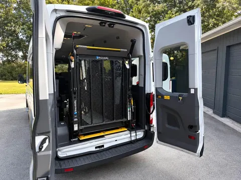 Rear doors open showing a BraunAbility wheelchair lift folded upright