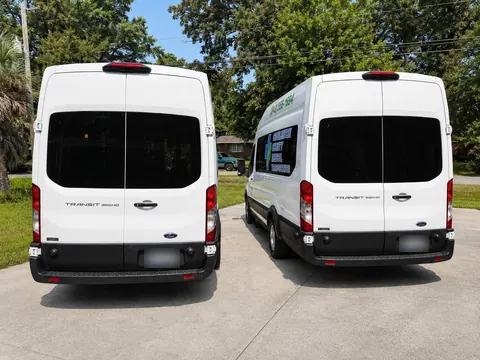 Rear view of two white Ford Transit vans with Transit 350HD badges on the rear doors