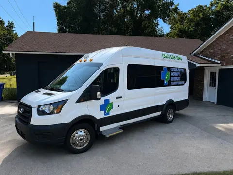 White Ford Transit high-roof van, front three-quarter view from the driver side